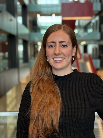 a woman with long red hair smiling