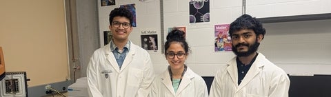 two men and a woman in lab coats