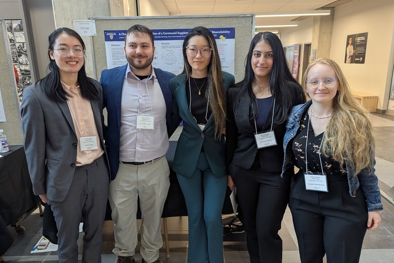 three women and a man smiling