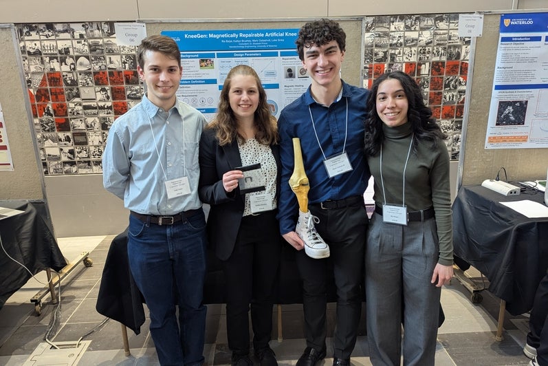 a group of people one of them is holding a fake knee with a shoe on it