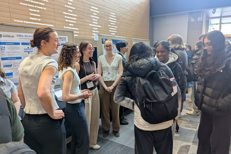 people looking at poster boards