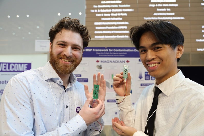 two men holding green objects