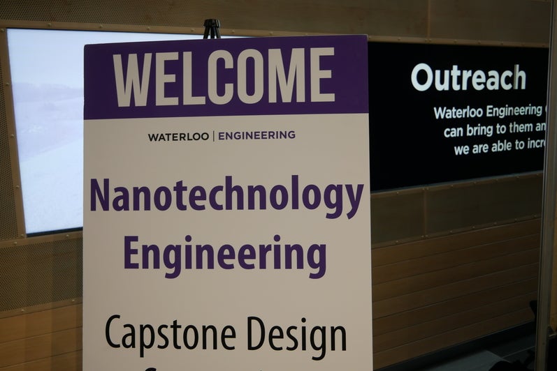 White welcome sign with purple lettering