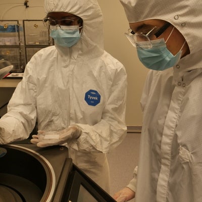 two technicians working on equipment in the clearoom