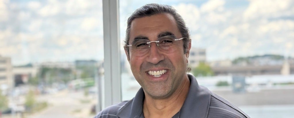 a man wearing glasses smiling