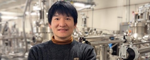 a man with black hair smiling