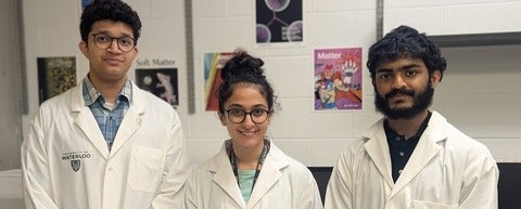 two men and a woman in lab coats