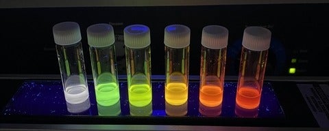 colourful test tubes with white lids