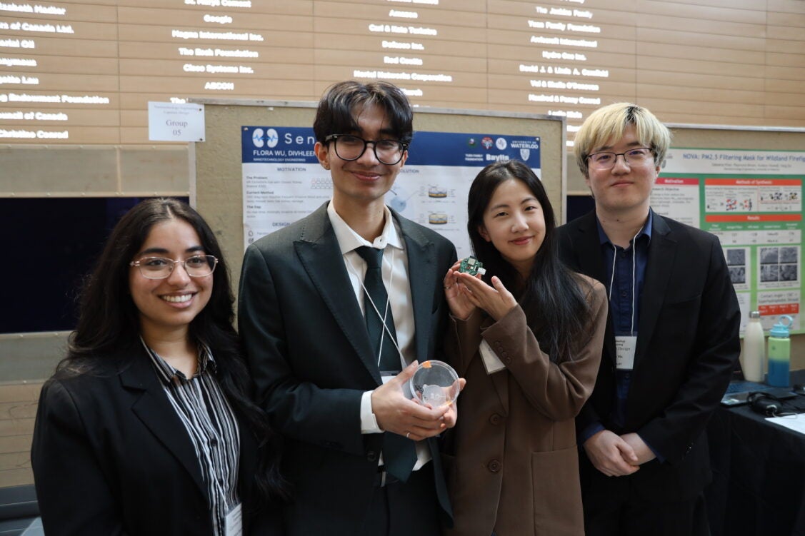 two women and two men holding objects