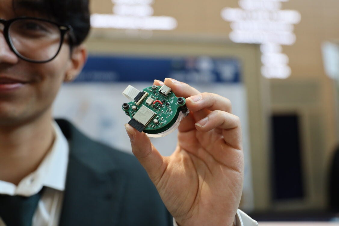 a man holding a green device