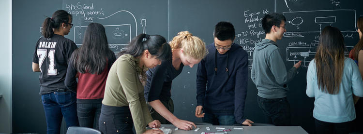 students writing on a board