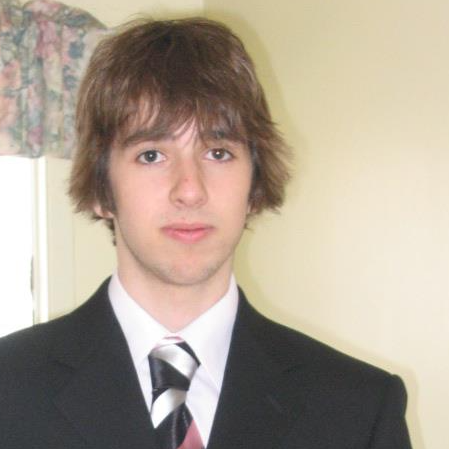 Graeme Williams, posing in a suit and tie, in his first year of university