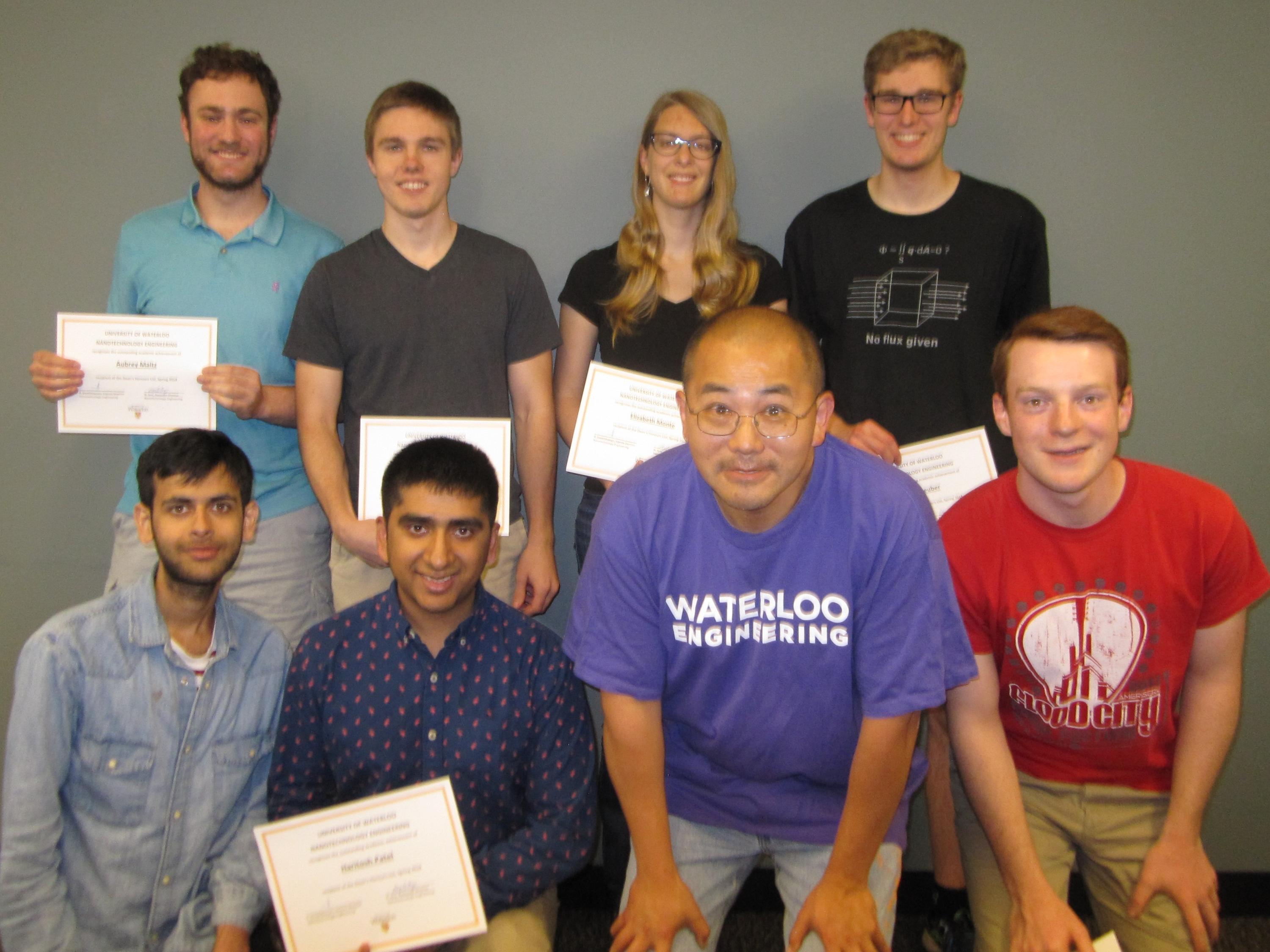 students and professor with certificate