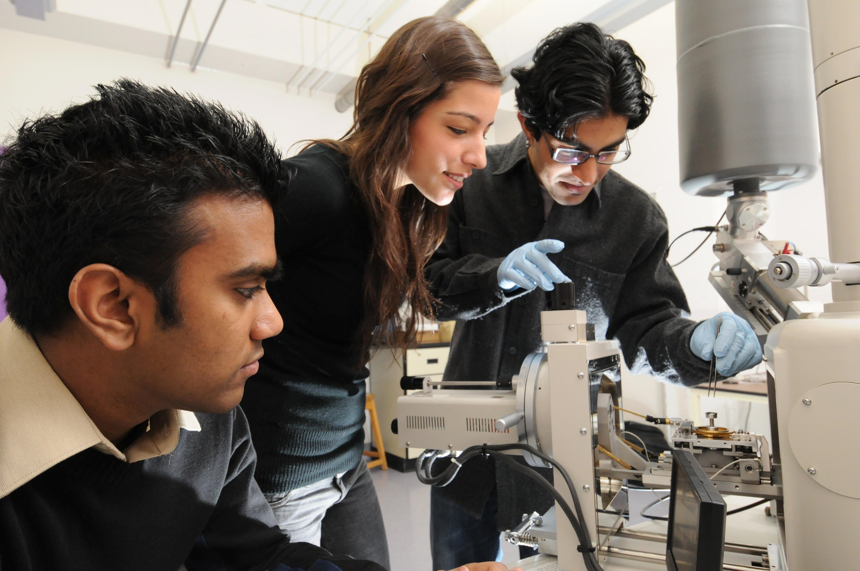 Three students working in the lab.
