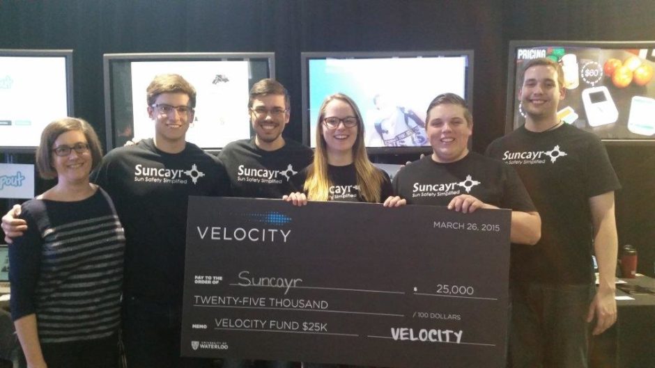 Suncayr, posing with a giant cheque the represents their $25,000 win at a Velocity competition.