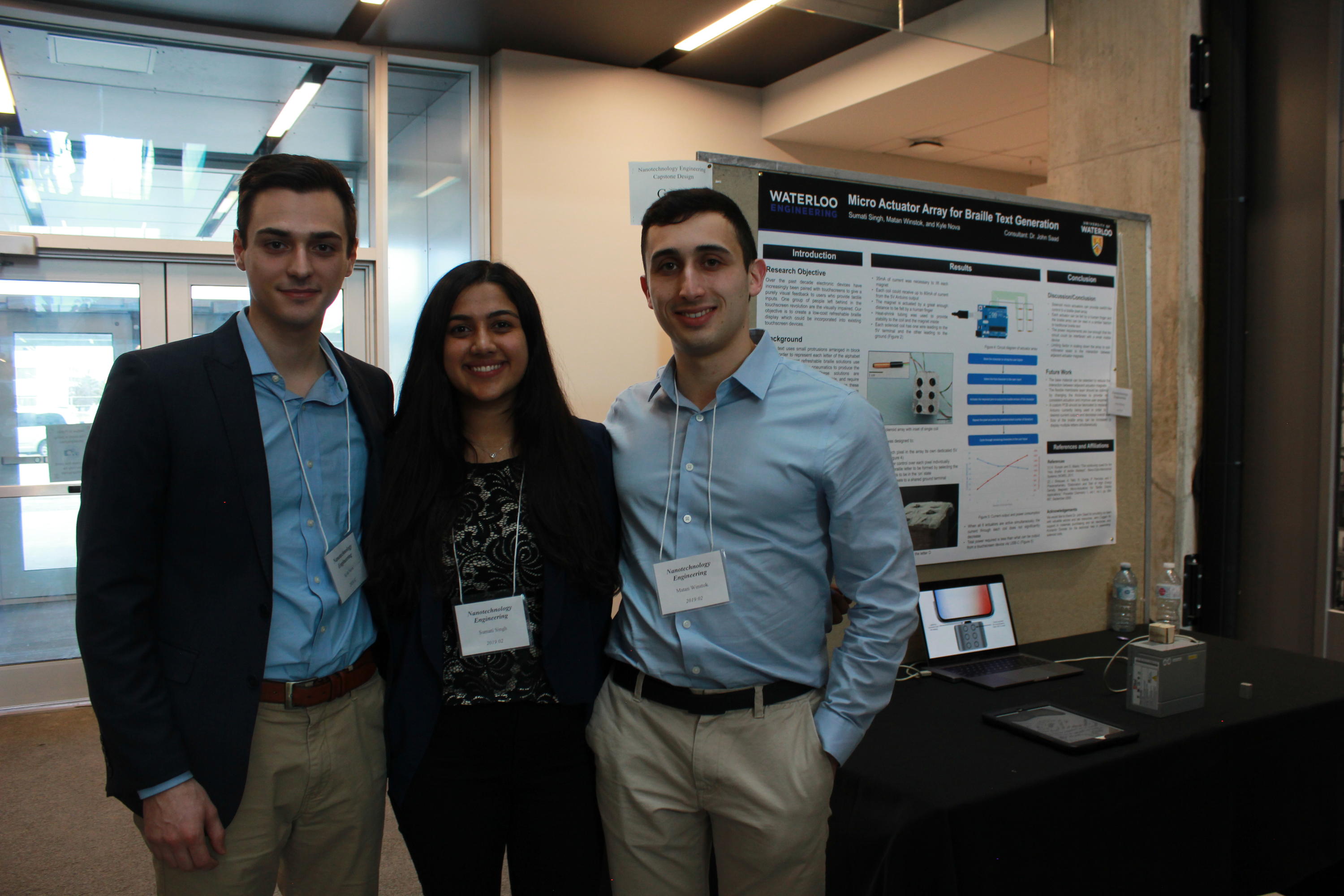 Team 2 students with their project poster at the 2019 Capstone Design Symposium.
