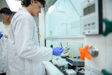two students wearing lab coats