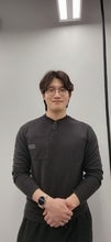 a man with black hair and glasses