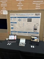 a poster board with two computers in front
