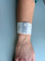 an arm wearing a white wristband 