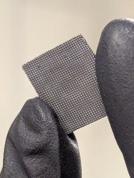 black gloves holding a black rectangle