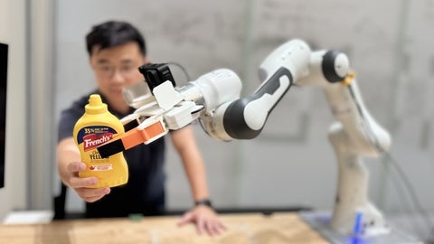 Dr. Thomas M Kwok illustrates the robotic capabilities of the AIR Lab