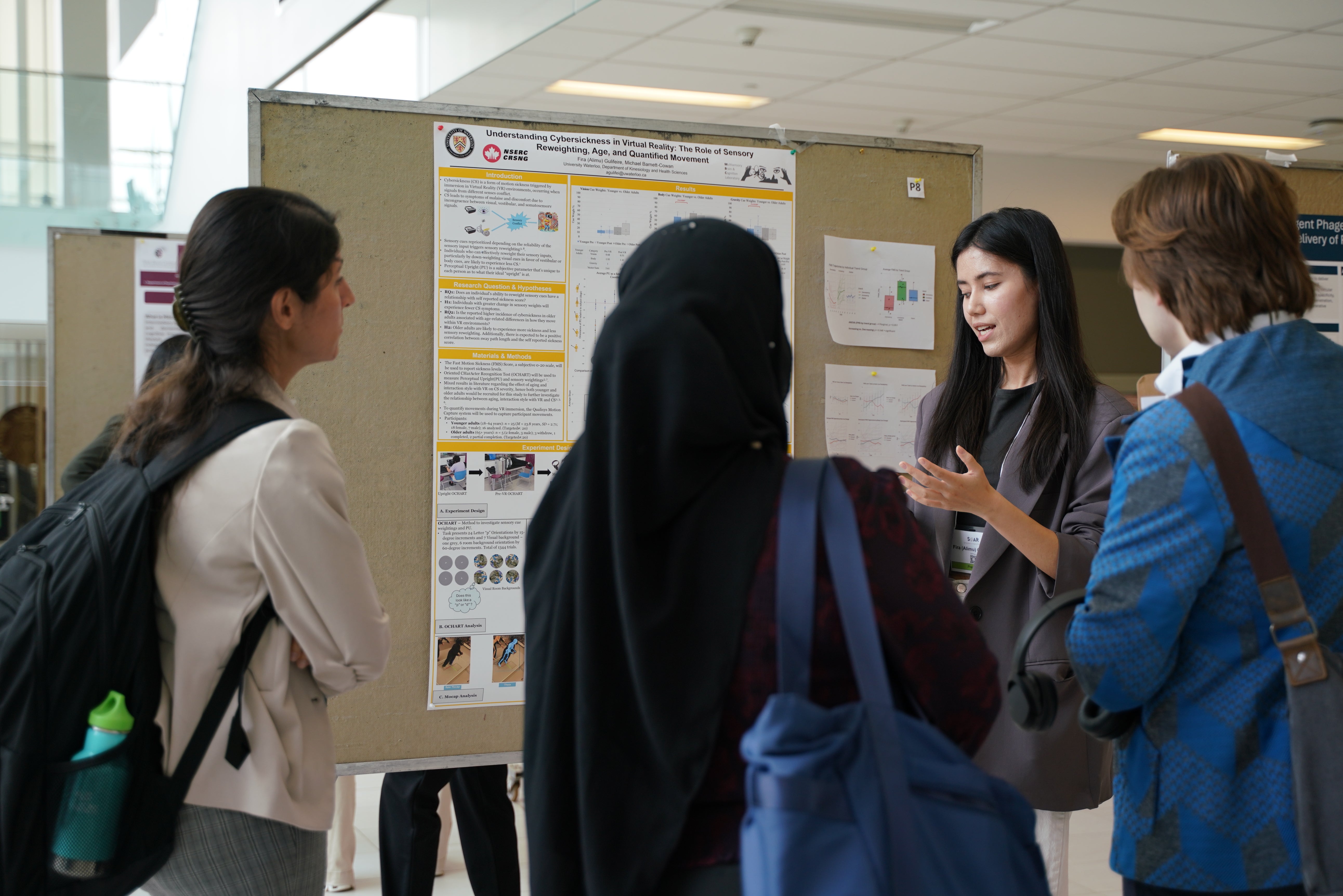 A student presents their poster to a group at the Symposium on Aging Research 2025.
