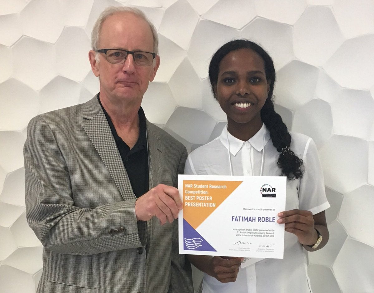 Paul Stolee presenting Fatimah Roble with Best Poster Award
