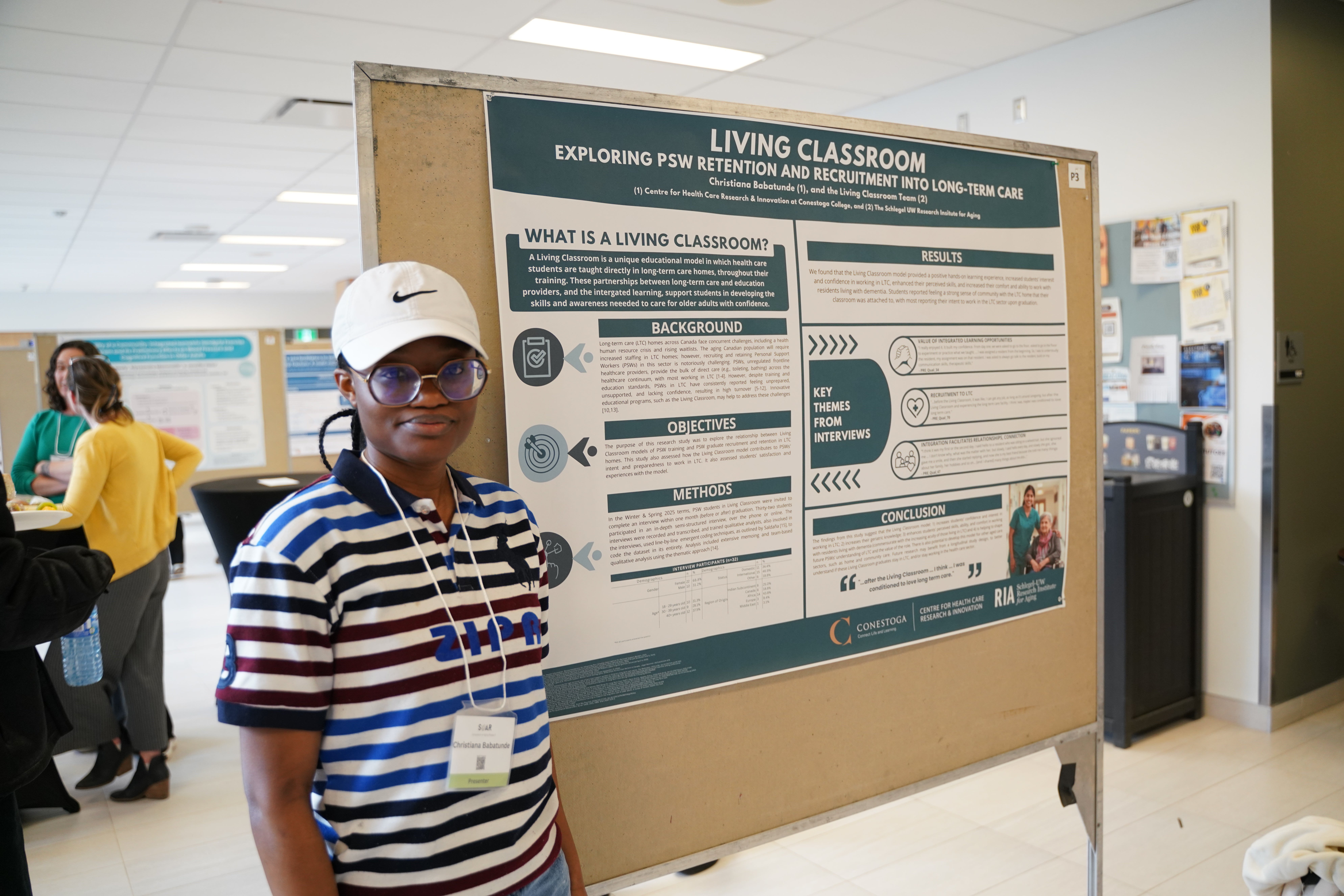 A presenter stands by their poster at the 2026 Symposium on Aging Research