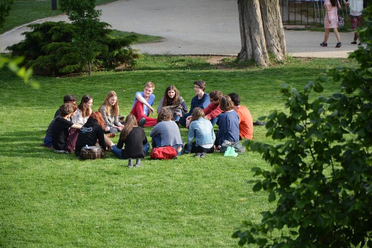 students sitting in a circle outside