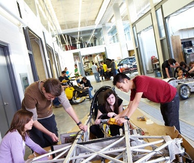 Engineering students work on car prototypes