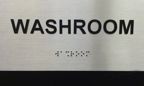inclusive bathroom sign