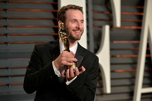 Chris Williams holding his Oscar award