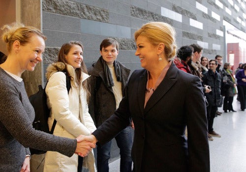President of Croatia shaking hands with students in iQC