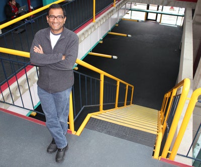 Mahesh Tripunitara standing in front of DC stairs on second floor