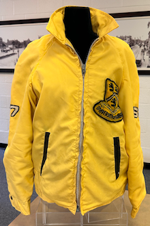 Front view of yellow Waterloo jacket with a logo patch on it