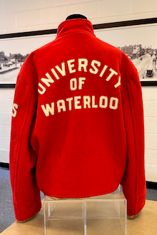 Back view of a red jacket with University of Waterloo on it