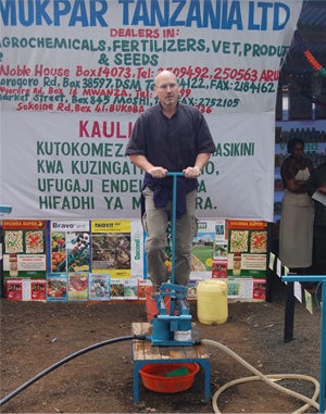 Larry Swatuk tests a 'treadle pump' in Tanzania