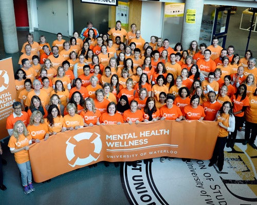 Group of students wearing orange mental health awareness t-shirts
