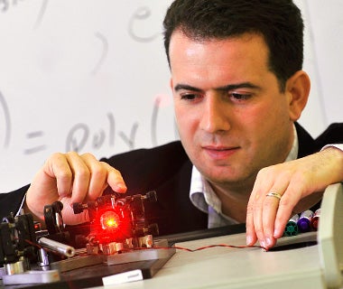 Michele Mosca conducting an optics experiment