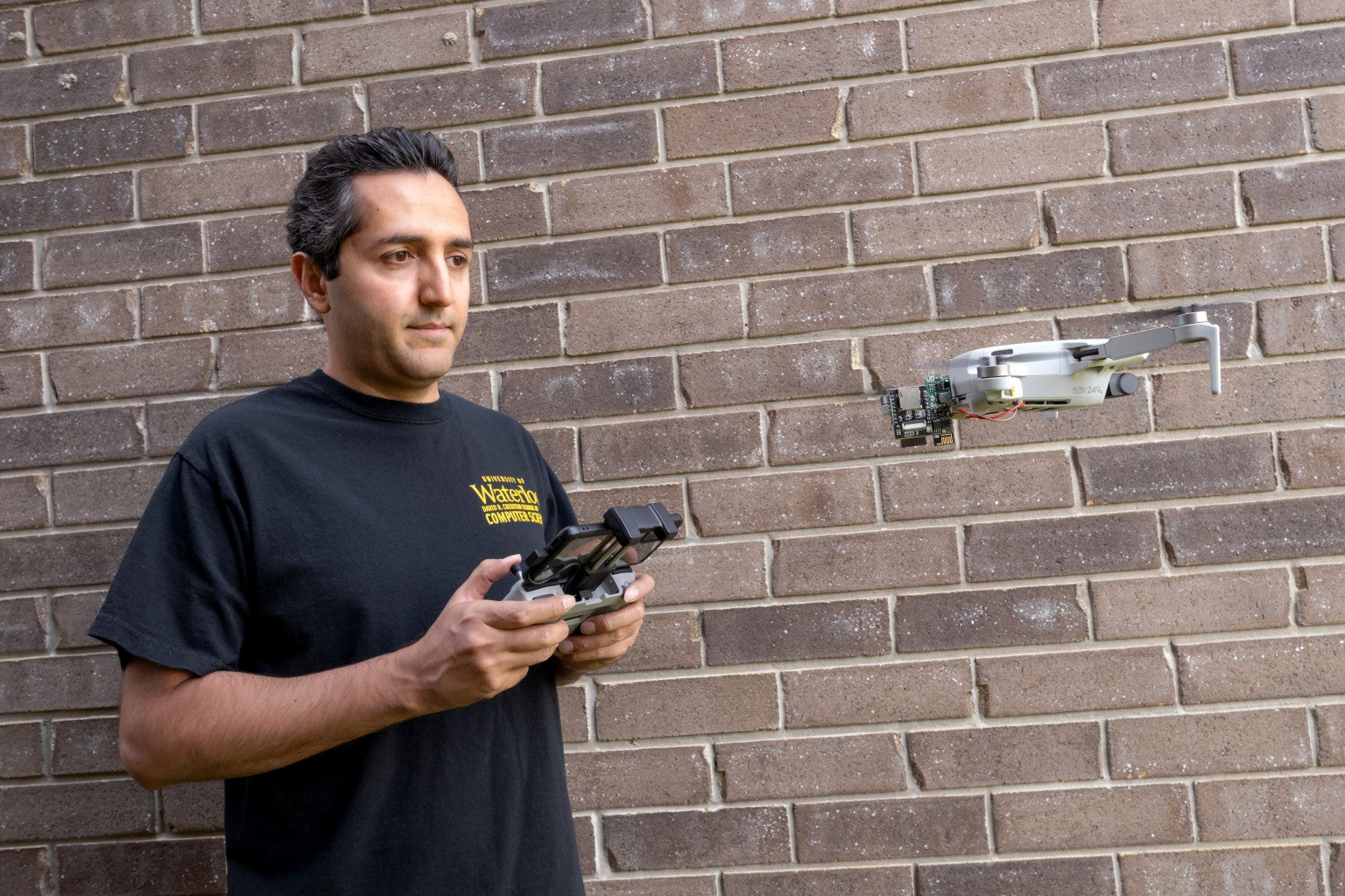 Professor Ali Abedi tests out Wi-Peep, a drone-powered device that can use WiFi networks to see through walls