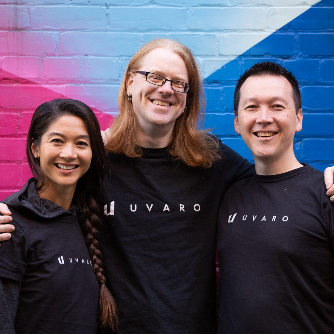 Uvaro founders in black shirts against a colourful background
