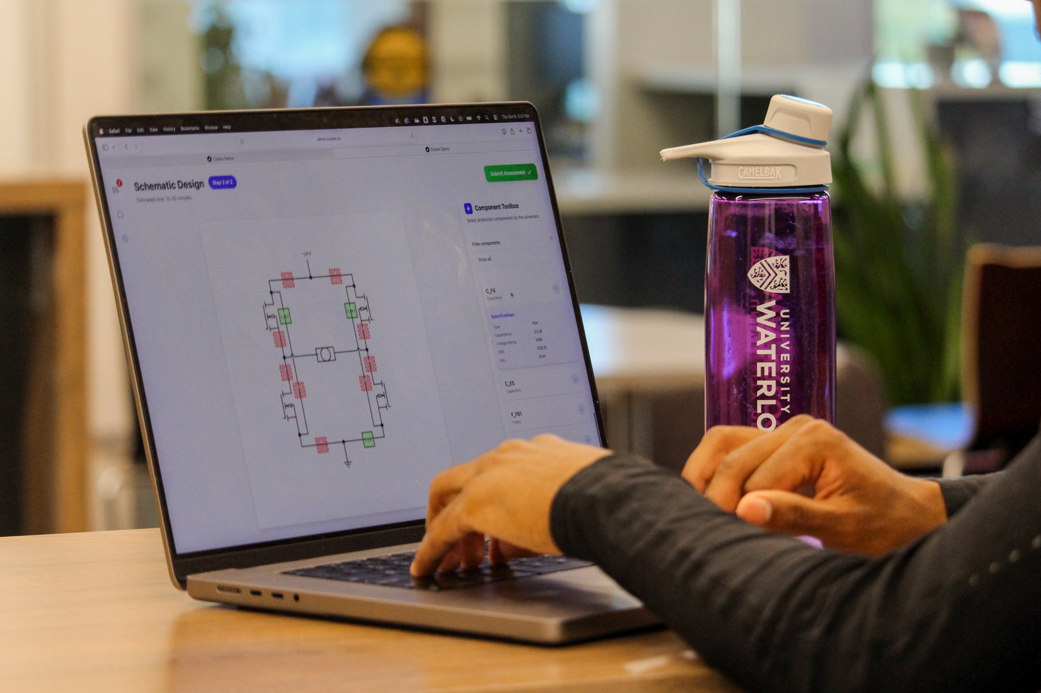 Nain Abdi using a laptop with the Colare hiring platform assessment process on the screen