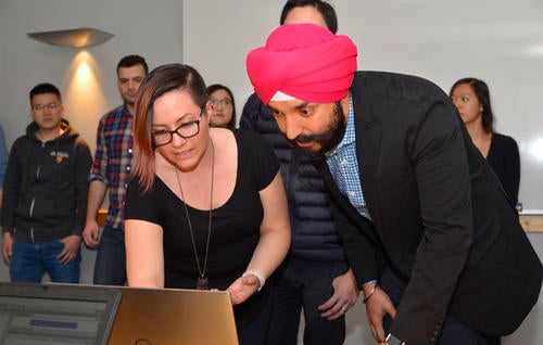 Minister Navdeep Bains looks at AI technology developed by Waterloo researchers
