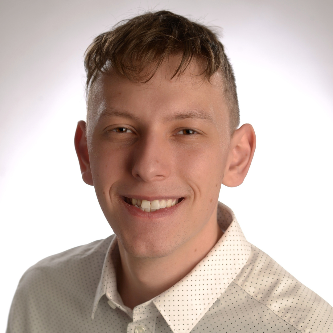 Andrew Watford wearing a white collared shirt against a white background