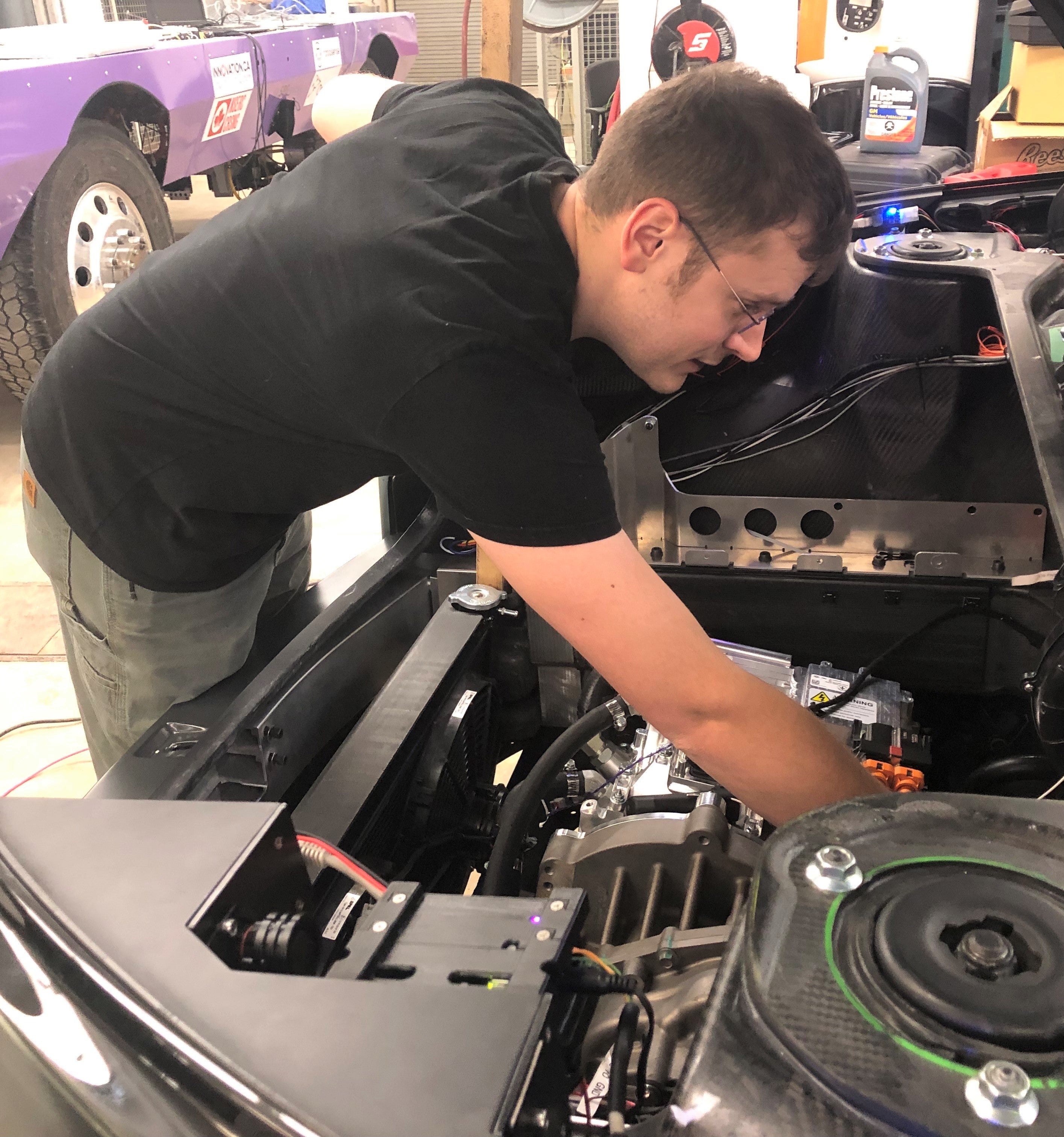 Jeff Graansma checks under the hood of Arrow concept car.