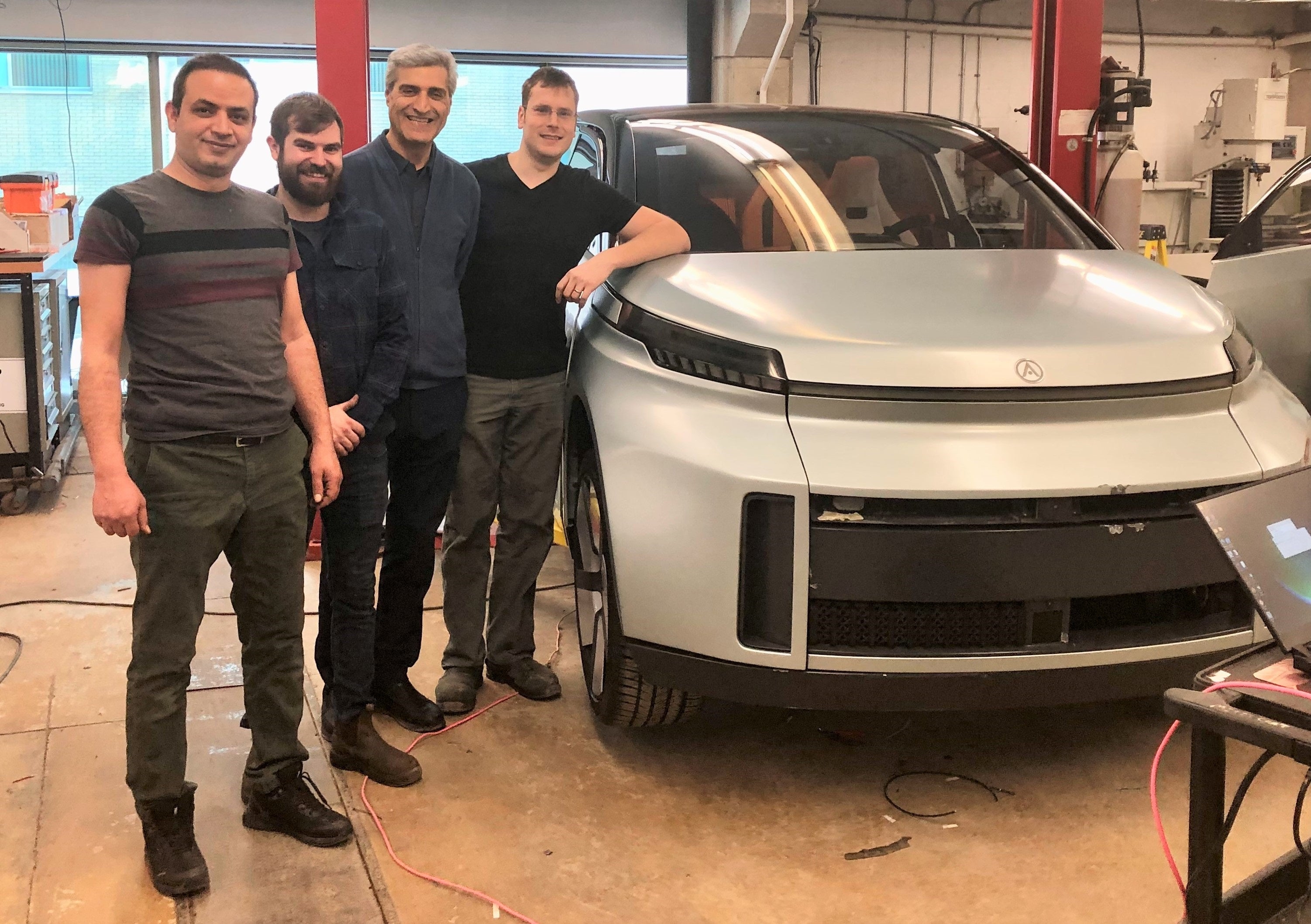 Amir Soltani (l-r), Mike Duthie, Amir Khajepour and Jeff Graansma in their Waterloo Engineering lab with the Arrow concept car.
