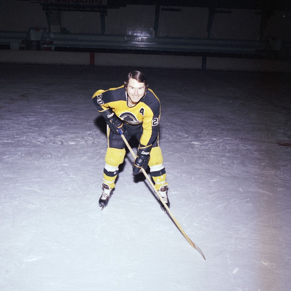 Vintage photo of Cam Crosby wearing black and gold Warriors hockey uniform 
