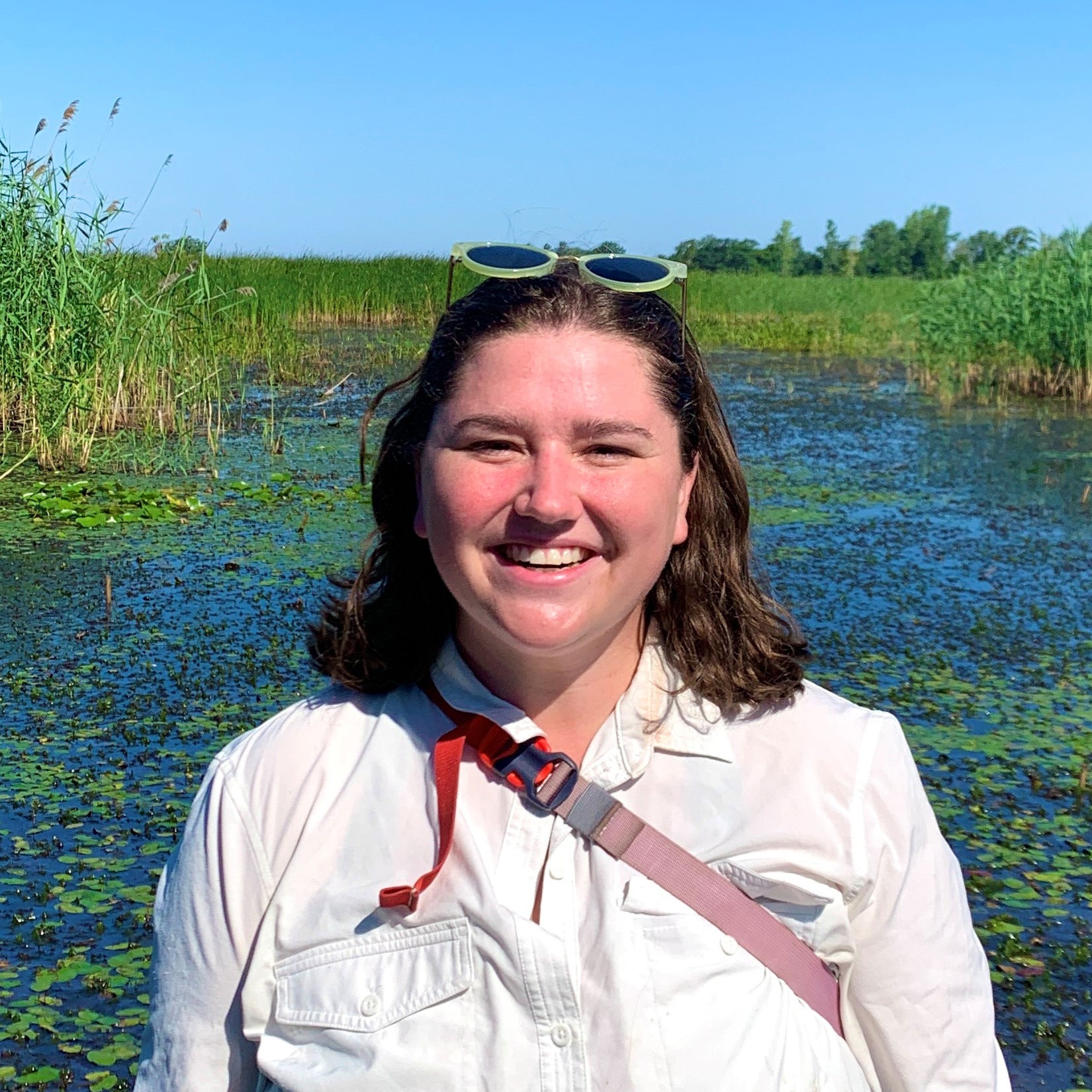 Claire Schon standing by a wetland.
