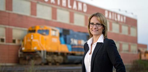 Cprina Moore stands beside train tracks